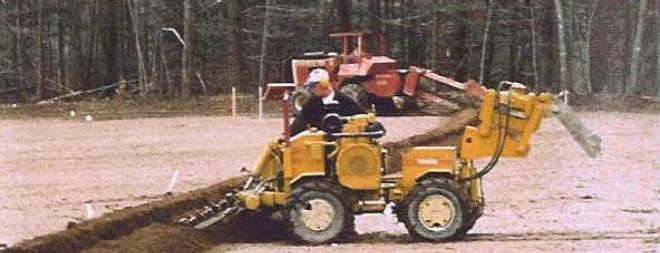 Athletic field irrigation - trenching irrigation pipes Trenching irrigation pipes on new field construction